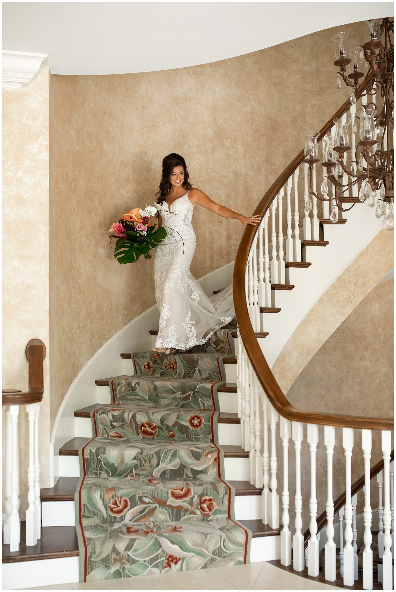 Bride walking down grand stairwell at The Estate at Cherokee Dock
