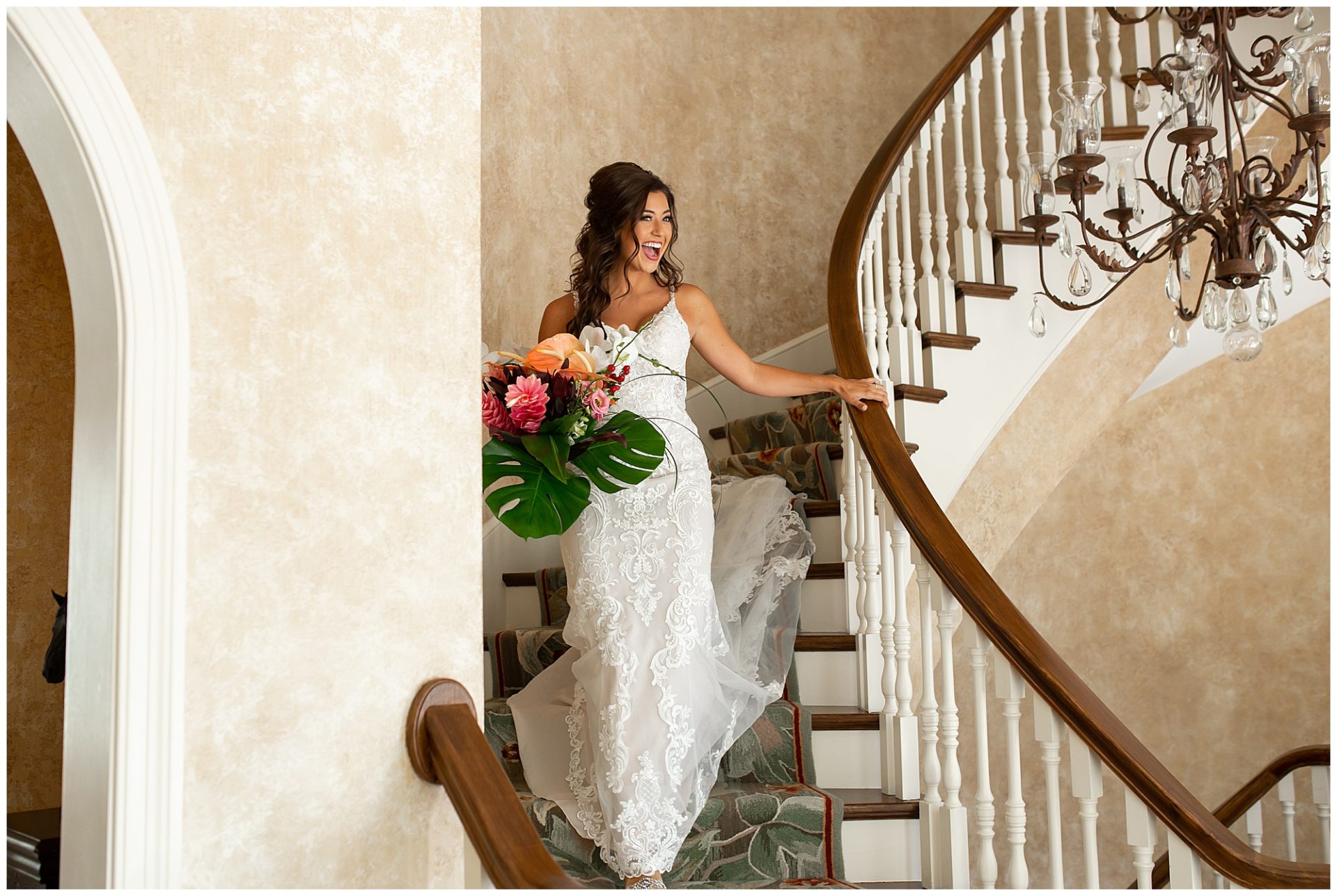 Bride walking down grand stairwell at The Estate at Cherokee Dock