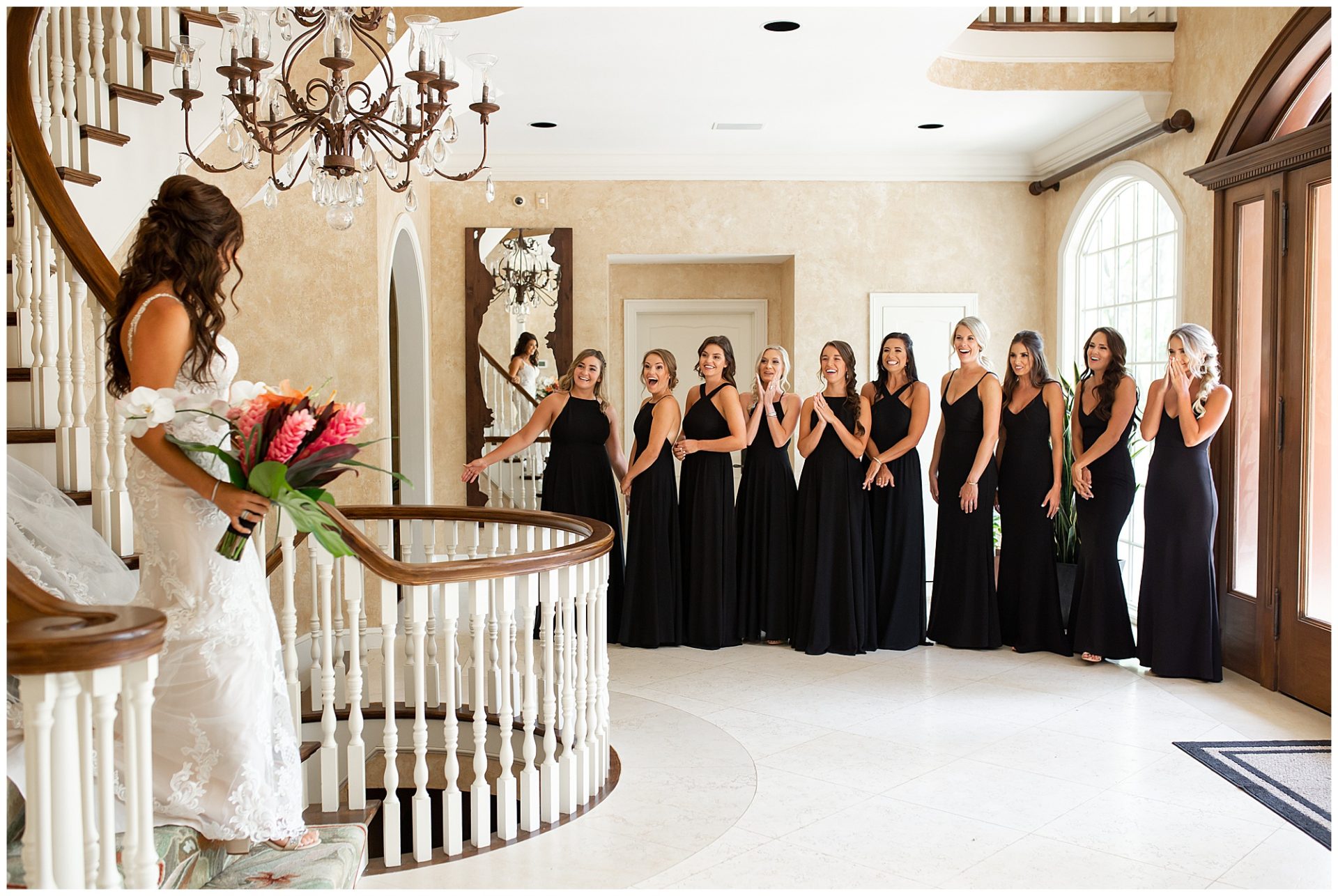 Bride first look with bridesmaids walking down grand stairwell at The Estate at Cherokee Dock